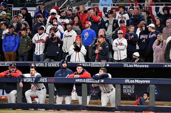 10/31/21 - Atlanta - Atlanta Braves players and fans react during the bottom of the ninth inning trailing the Houston Astros four runs in game 5 of the World Series at Truist Park, Sunday, October 31, 2021, in Atlanta. The Astros won game 5, 9-5. Hyosub Shin / Hyosub.Shin@ajc.com