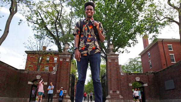 Obasi Shaw poses outside the gates of Harvard Yard in Cambridge, Mass., Thursday, May 18, 2017. Shaw, an English major who graduates from Harvard next week, is the university's first student to submit his final thesis in the form of a rap album. The record, called âLiminal Minds,â has earned the equivalent of an A- grade, good enough to ensure that Shaw will graduate with honors at the universityâs commencement next week.  (AP Photo/Charles Krupa)