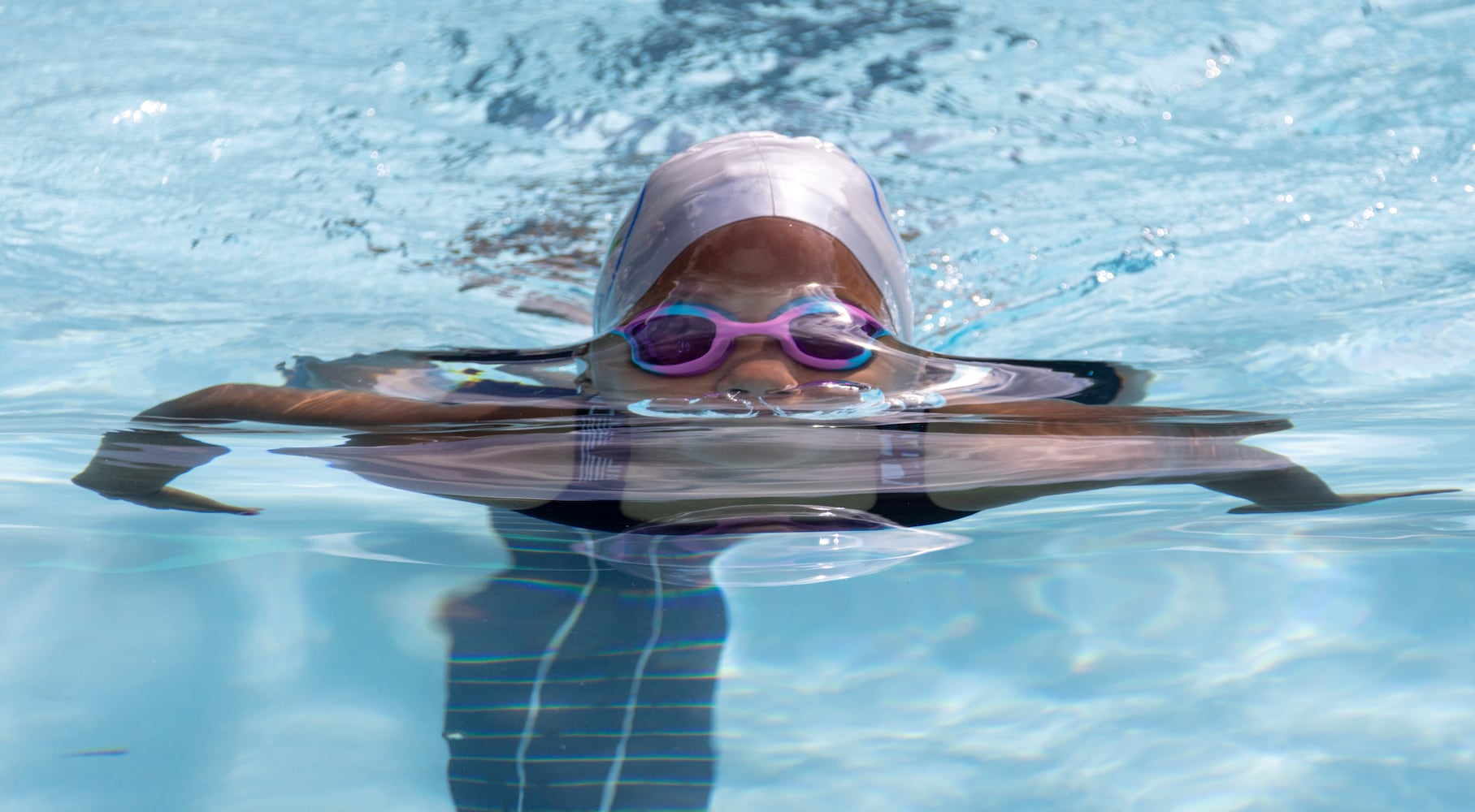 Sanaya McClendon, 8, competes in the breast stroke in a swim meet at Leslie Beach Club in Atlanta on Saturday, May 21, 2022.    According to the USA Swimming Foundation, while most Americans learn how to swim during childhood, 64% of Black children in America have little to no swimming ability. (Bob Andres / robert.andres@ajc.com)