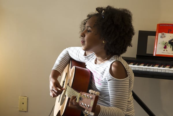 Aryanna Maymi-Booker, 9, listens to instruction during an afternoon session of the Kevin Baker Music Program. REANN HUBER / REANN.HUBER@AJC.COM