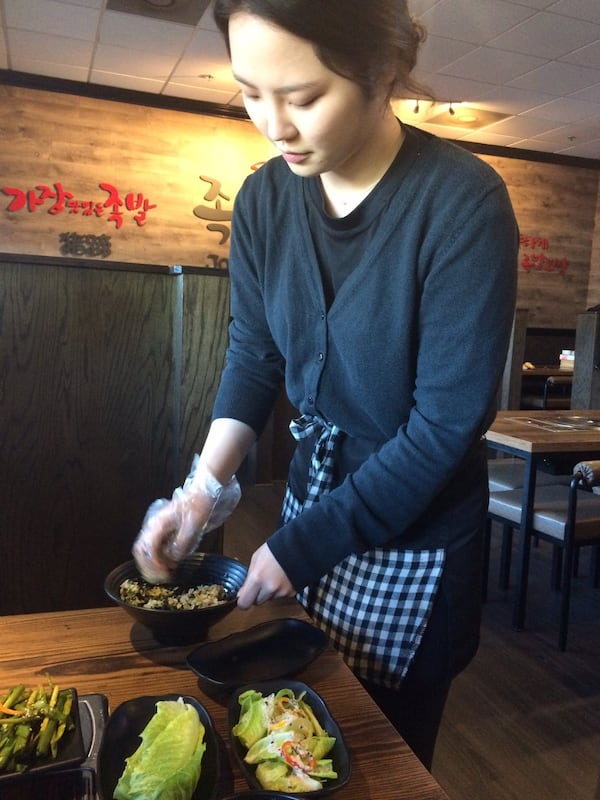 A server at Jok Ga A Dong Chim in Duluth rolls Korean rice balls tableside. CONTRIBUTED BY WENDELL BROCK