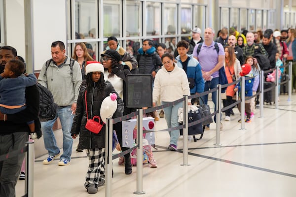 Travelers descend on Hartsfield-Jackson Atlanta International Airport in the final days of the holiday season. Friday, December 20, 2024 (Ben Hendren for the Atlanta Journal-Constitution)