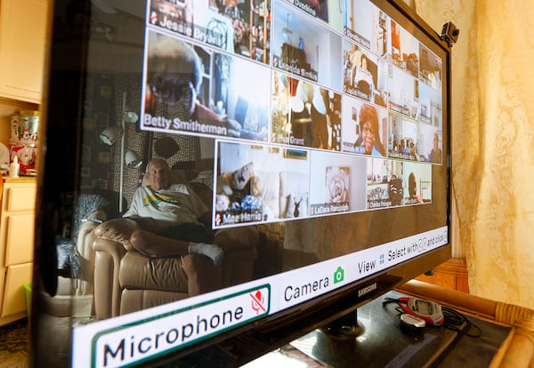 A new program designed to ease isolation "is kind of like Zoom but it's made specifically for seniors," said Ann Marie Winter, executive director of the Area Agency on Aging Pasco-Pinellas, Florida. Bill McDonald, 75, is reflected in his television as he participates in an online meeting while at his home in New Port Richey. (Chris Urso/Tampa Bay Times/TNS)