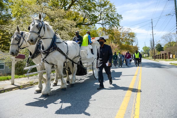 Participants walk along Bolton Road to the site of the former Chattahoochee Brick Company during a sacred event to commemorate the lives lost during the period the company used the convict lease system. The event included a procession, prayers, libations, community testimonials and site consecration Saturday, April 3, 2021, in Atlanta. (Photo: Daniel Varnado for The Atlanta Journal-Constitution)