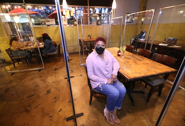 Deborah VanTrece, owner and chef of Twisted Soul Cookhouse, had plexiglass cubicles installed in her restaurant to help protect and socially distance patrons. Curtis Compton/curtis.compton@ajc.com