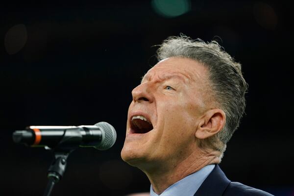 Lyle Lovett signs the national anthem before an NFL football game between the Houston Texans and the New England Patriots Sunday, Dec. 1, 2019, in Houston. (AP Photo/David J. Phillip)