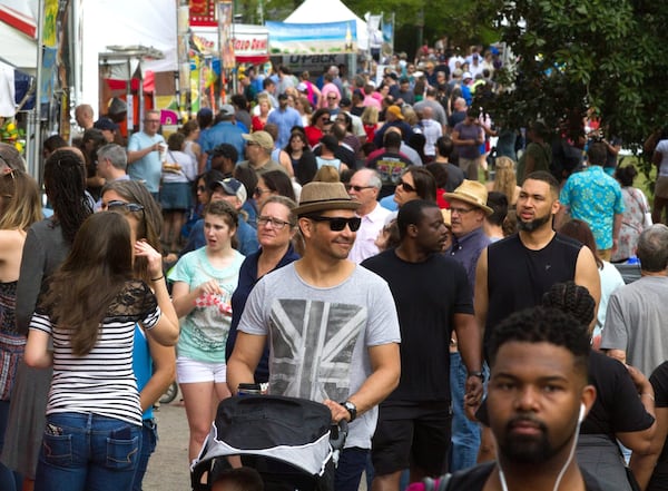 A large crowd walks past the food and artist booths during the 82nd Annual Atlanta Dogwood Festival in Piedmont Park. STEVE SCHAEFER / SPECIAL TO THE AJC