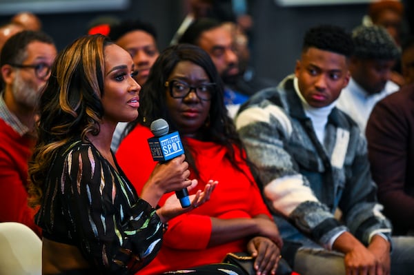 Dr. Contessa Metcalfe (with microphone) speaks during a community event about ending the HIV epidemic in Black communities at the Gathering Place in Atlanta Thursday, Dec. 1, 2022. (Daniel Varnado/For the AJC)