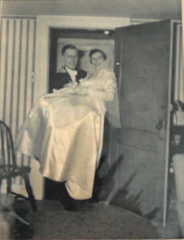 Ken Hetzel carries his bride, Ann Hetzel, through the threshold on November 22, 1950.