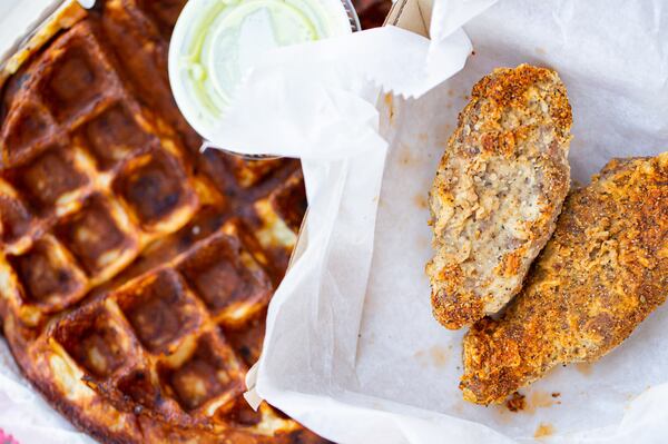 The jalapeno cheddar waffle with guacamole sauce and plant-based Vicken tenders at Southern Feed Store in East Atlanta.