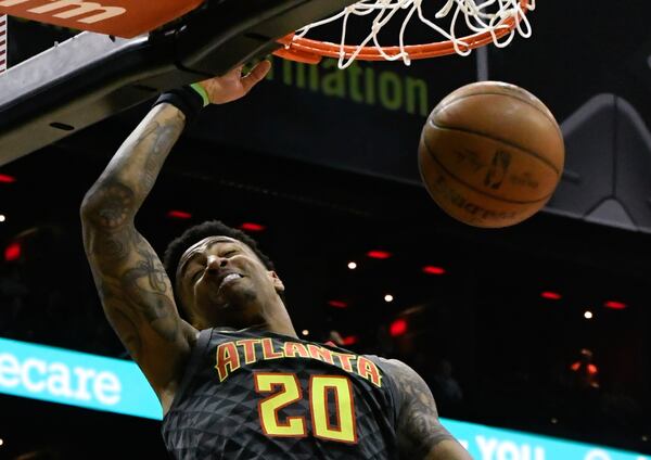 Atlanta Hawks forward John Collins dunks during the first half of an NBA basketball game against the Philadelphia 76ers Tuesday, April 10, 2018, in Atlanta. (AP Photo/John Amis)