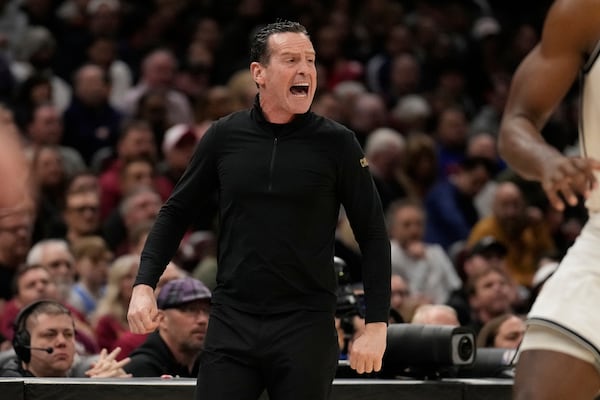 Cleveland Cavaliers head coach Kenny Atkinson shouts in the second half of an NBA basketball game against the Brooklyn Nets Tuesday, March 11, 2025, in Cleveland. (AP Photo/Sue Ogrocki)