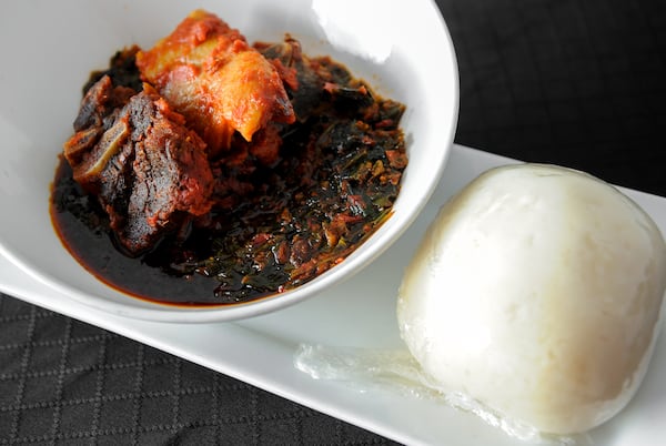 Efo Riro- Spinach cooked with dried fish, prawns and stockfish served with a side of pounded yams. (Beckysteinphotography.com)