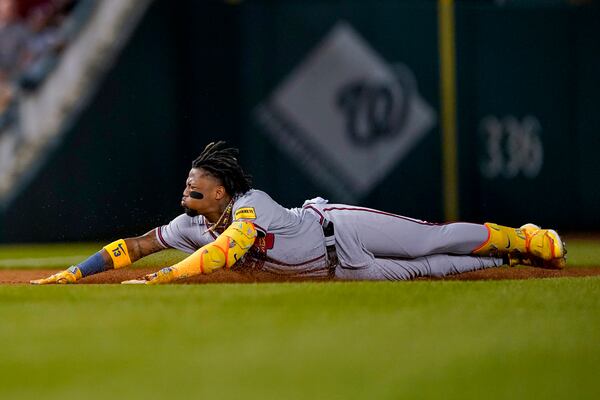 Atlanta Braves' Ronald Acuña Jr. slides into third base on a triple against the Washington Nationals during the third inning of a baseball game at Nationals Park, Thursday, Sept. 21, 2023, in Washington. (AP Photo/Andrew Harnik)