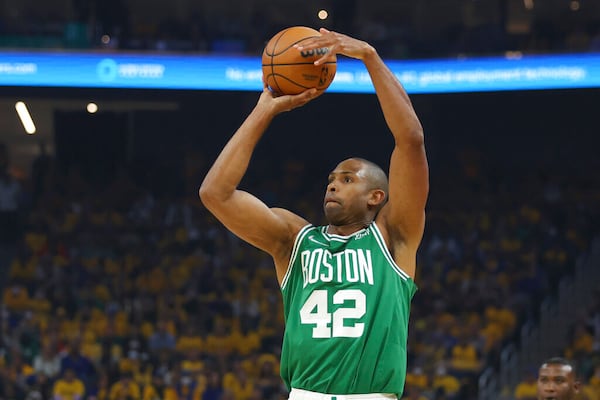 Boston Celtics center Al Horford (42) shoots against the Golden State Warriors during the first half of Game 1 of basketball's NBA Finals in San Francisco, Thursday, June 2, 2022. (AP Photo/Jed Jacobsohn)