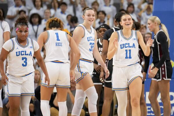 UCLA players celebrate during the first half of an NCAA college basketball game against South Carolina, Sunday, Nov. 24, 2024, in Los Angeles. (AP Photo/Eric Thayer)