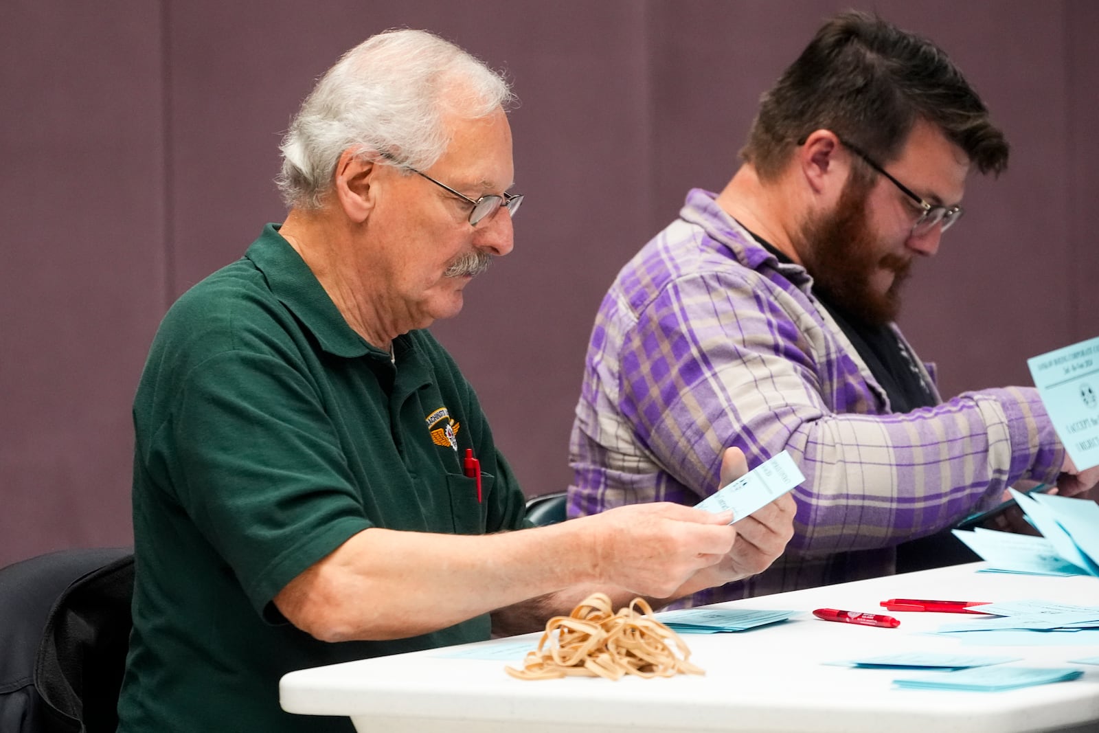 Volunteers tally votes on a new contract offer from Boeing, Monday, Nov. 4, 2024, at the IAM District 751 Union Hall in Seattle. (AP Photo/Lindsey Wasson)