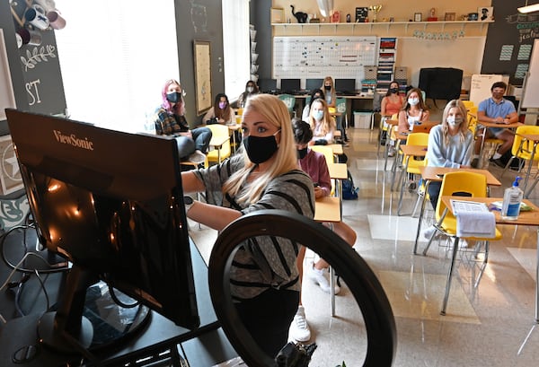 Jordan Kohanim (foreground) talks to students who joined via online as she works with students to create a yearbook that marks the school's 100th anniversary at Milton High School on Oct. 15, 2020. (Hyosub Shin / Hyosub.Shin@ajc.com)