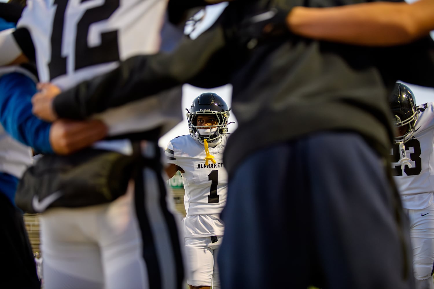 Alpharetta's Sean Wilson huddles with the team during the Alpharetta at Roswell football game, November 3, 2023. (Jamie Spaar for the Atlanta Journal Constitution)