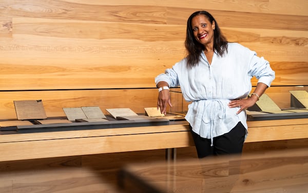 Chief Program Officer Kama Pierce poses with personal papers of Dr. Martin Luther King Jr.  preserved in the Voice to the Voiceless Gallery at the National Center for Civil and Human Rights in Atlanta on Thursday, July 11, 2024. (Seeger Gray / AJC)