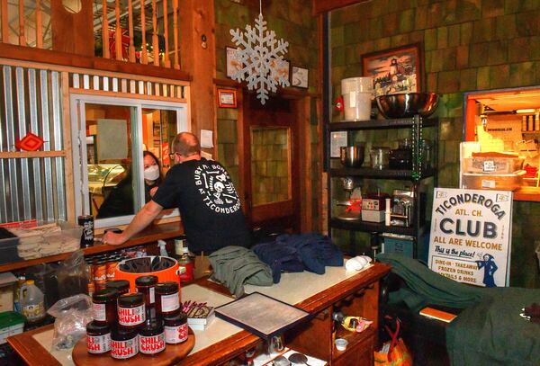 211220 Atlanta, Ga: Ticonderoga Club co-owner Greg Best (at window) converses with a walk-up customer at the Club's Krog Street Market.  (Chris Hunt for The Atlanta Journal-Constitution)