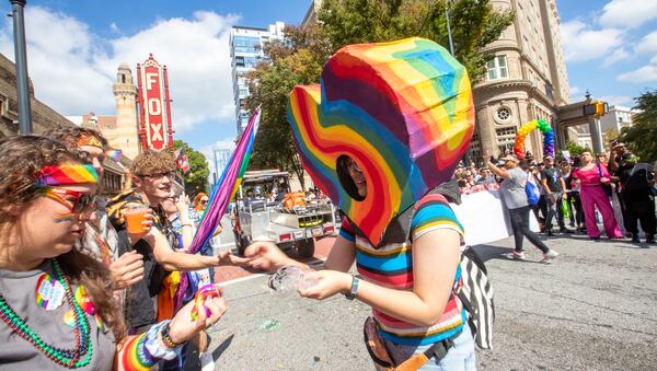 Jessie Shann (right) hands out wristbands during last year's parade. This marked the first time the parade had been held since 2019 due to the pandemic. Photo: Jenni Girtman for the AJC