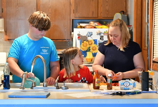 Jennifer Paris is preparing snacks for her two children Peyton, 12, and Cason, 10, after they finished their homework online at their home in Acworth on Friday, November 13, 2020.  (Hyosub Shin / Hyosub.Shin@ajc.com)