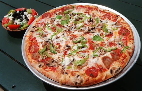 Mo's Pizza on Briarcliff Road in Atlanta has been around since 1979. Pictured are Mo's deluxe pizza and a Greek salad. Atlanta Journal-Constitution file