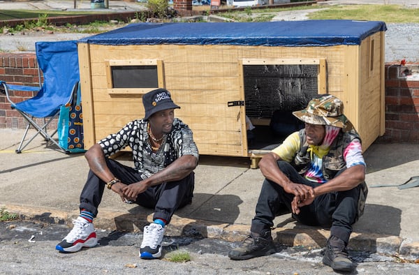 Brandon Brando (left) talks with Reginald Driskell, a homeless man living in southwest Atlanta who he befriended and constructed a 7 by 3 foot wooden structure for the man with circulating air to get him out of an old cardboard box he's been living in. He'd like to do that for others as well. 
 PHIL SKINNER FOR THE ATLANTA JOURNAL-CONSTITUTION.