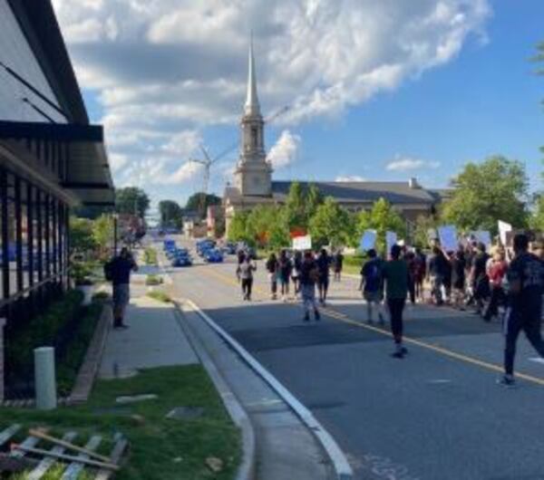 Police are trying to stop protesters at an intersection in Lawrenceville.