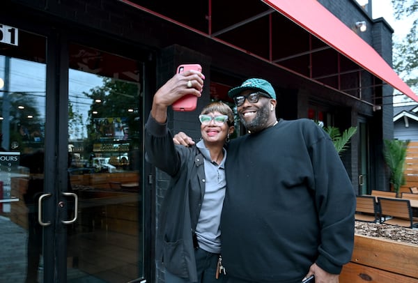 Killer Mike (right) poses with customer Jackie Kimbrew during the soft opening of Bankhead Seafood on Wednesday, Nov. 13, 2024, in Atlanta. (Hyosub Shin/AJC)