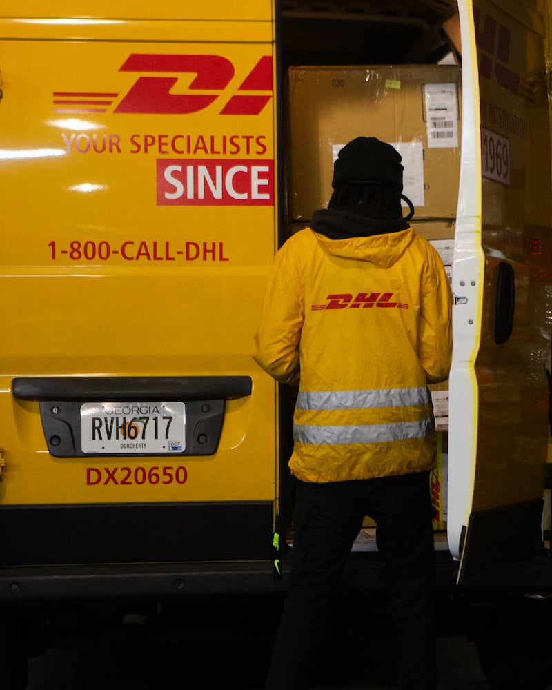 A DHL employee checks his truck on Wednesday, December 16, 2020, at DHL Express in Atlanta. Workers at the shipping center worked to fulfill orders during the holiday rush. CHRISTINA MATACOTTA FOR THE ATLANTA JOURNAL-CONSTITUTION.