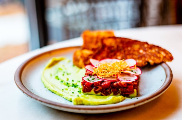 Steak tartare with avocado, shallot, radish and black garlic brioche. CONTRIBUTED BY HENRI HOLLIS