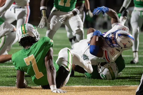 Makari Bodiford, running back for Walton is tackled during the Walton vs. Buford High School Football game on Friday, Nov. 18, 2022, at Buford High School in Buford, Georgia. (Jamie Spaar for the Atlanta Journal Constitution)