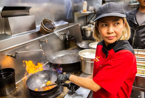 Tukta Chadwell, executive chef at 26 Thai Kitchen & Bar, prepares to stir-fry chicken and vegetables for the pineapple boat dish. Ryan Fleisher for The Atlanta Journal-Constitution