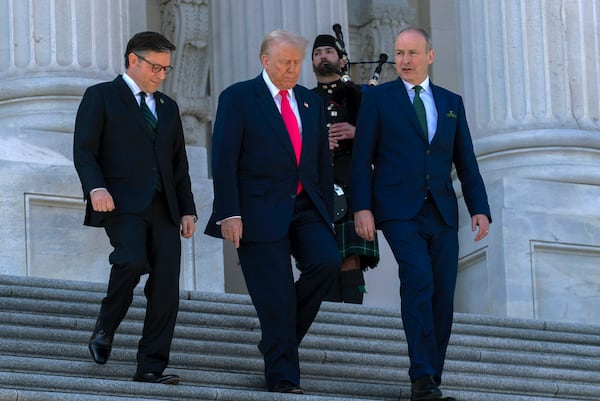 President Donald Trump, center, accompanied by Speaker of the House Mike Johnson, R-La., left, and Ireland's Prime Minister Micheal Martin, walks down the stairs of the U.S. Caopitol, after a luncheon on Wednesday, March 12, 2025, in Washington. (AP Photo/Jose Luis Magana)