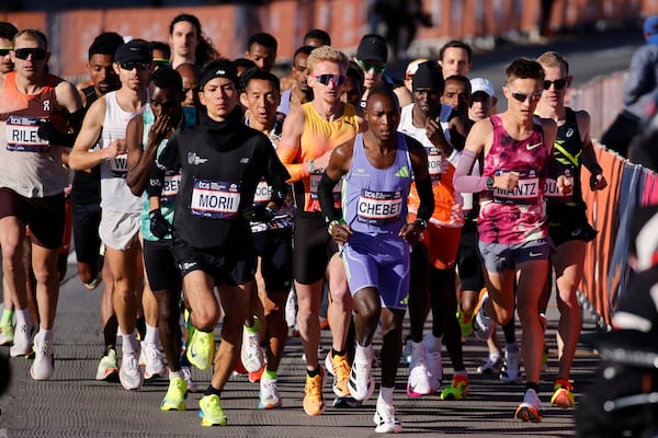 Yuma Morii, left, of Japan, makes his way onto the Verrazzano Narrows bridge with runners in the men's elite division make their way from the start line during the New York City Marathon, Sunday, Nov. 3, 2024, in New York. (AP Photo/Eduardo Munoz Alvarez)