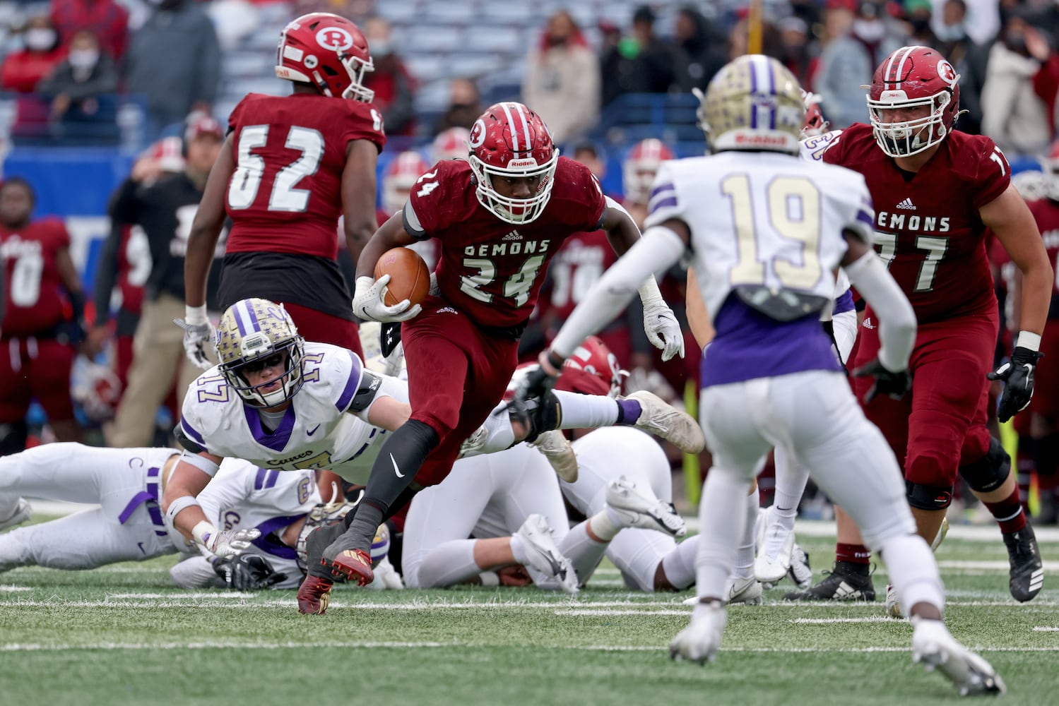 Warner Robins running back Malcom Brown (24) rushes for yards against Cartersville linebacker Gavin Geros (17, left) and Jaqualyn Mayhall (19) in the first half during the first half of the Class 5A state high school football final at Center Parc Stadium Wednesday, December 30, 2020 in Atlanta. JASON GETZ FOR THE ATLANTA JOURNAL-CONSTITUTION