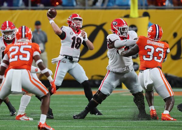 Georgia quarterback JT Daniels passes for a first down against Clemson during the first quarter Saturday, Sept 4, 2021, in the Duke's Mayo Classic in Charlotte, N.C. (Curtis Compton / Curtis.Compton@ajc.com)