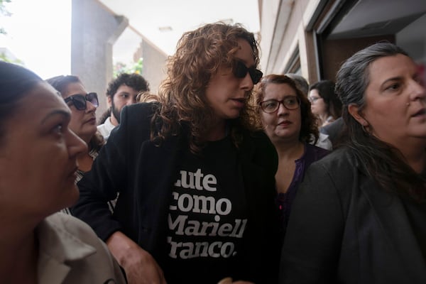 Monica Benicio, center, widow of slain councilwoman Marielle Franco, arrives to the Court of Justice to attend the trial of Franco's suspected murderers, in Rio de Janeiro, Wednesday, Oct. 30, 2024. (AP Photo/Bruna Prado)