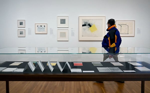 A guest views artworks during a preview of “Thinking Eye, Seeing Mind: The Medford and Loraine Johnston Collection” at High Museum of Art. (Hyosub Shin / AJC)