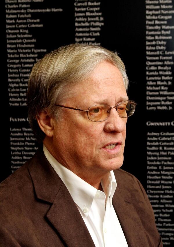 Portrait of the Rev. Bruce Cook in front of a list of murder victims, at Vinings United Methodist Church. He recently offered eight tips to help churches and other organizations prevent acts of violence. AJC FILE PHOTO