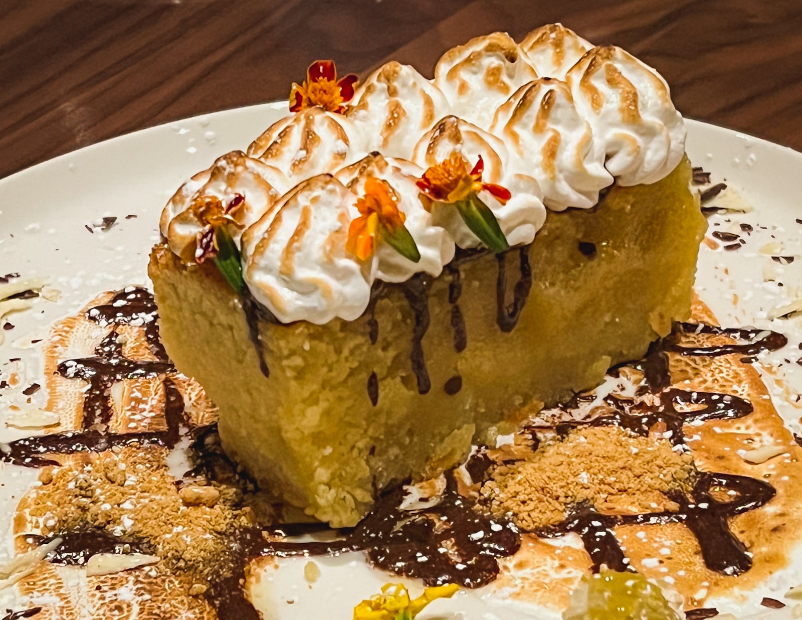 The campfire cake at Bask Steakhouse is built around a decadent, moist almond sponge. Henri Hollis/henri.hollis@ajc.com