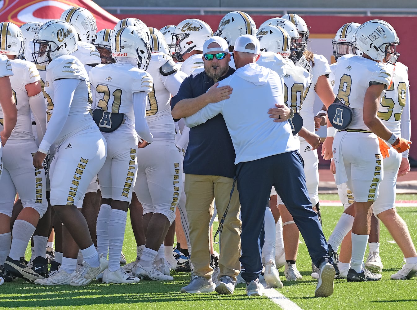 Apalachee coach Mike Hancock greets strength coach Matt Bradley before their game. Apalachee High School returned to the field against Athens Clarke Central Saturday September 28, 2024 in their first game since the school schooting earlier in the month.

 Nell Carroll for the Journal Constitution