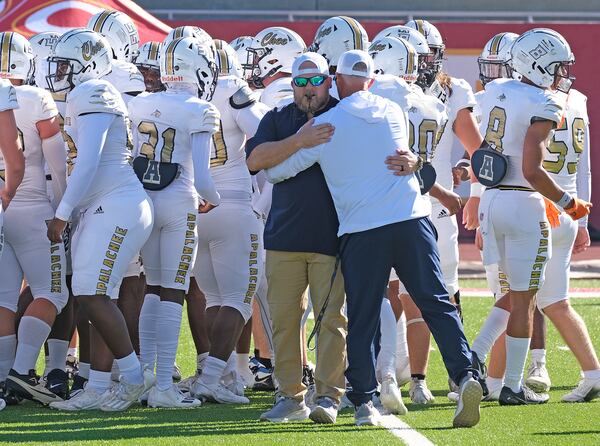 Apalachee coach Mike Hancock greets strength coach Matt Bradley before their game against Clarke Central in Georgia on Saturday Sept. 28, 2024.

 Nell Carroll for The Atlanta Journal-Constitution