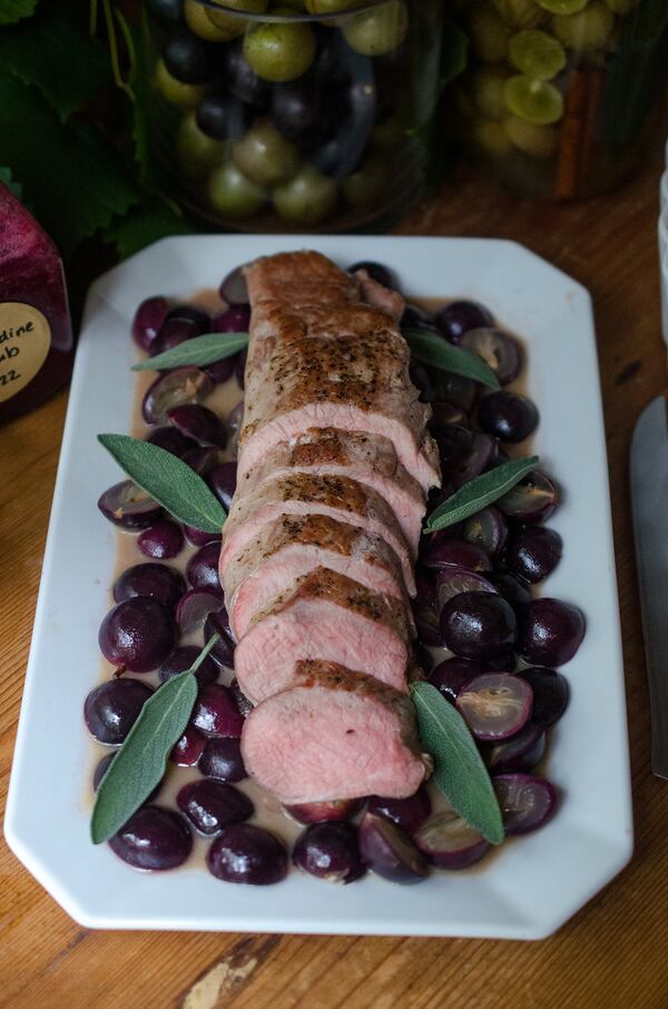 Tender pork tenderloin with roasted muscadines in a buttery mustard sauce. (Virginia Willis for The Atlanta Journal-Constitution)