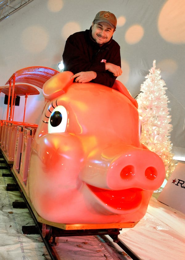 Jim Auchmutey in 2003 on the new version of the 'Pink Pig' at Rich's-Macy's at Lenox Square Mall, Atlanta. (JOEY IVANSCO/AJC staff)