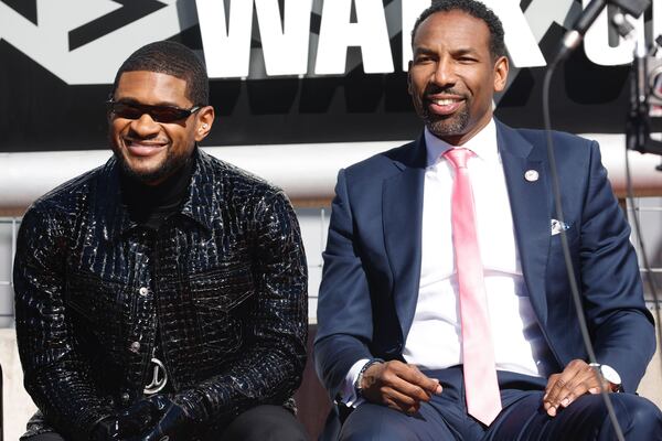 Usher with Atlanta Mayor Andre Dickens on Feb. 14, 2024 at a ceremony where the R&B singer received the city's highest honor The Phoenix Award. NATRICE MILLER/AJC