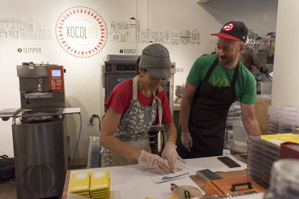 Elaine Read and Matt Weyandt, co-founders of Xocolatl, laugh while working in Atlanta last fall. DAVID BARNES / DAVID.BARNES@AJC.COM