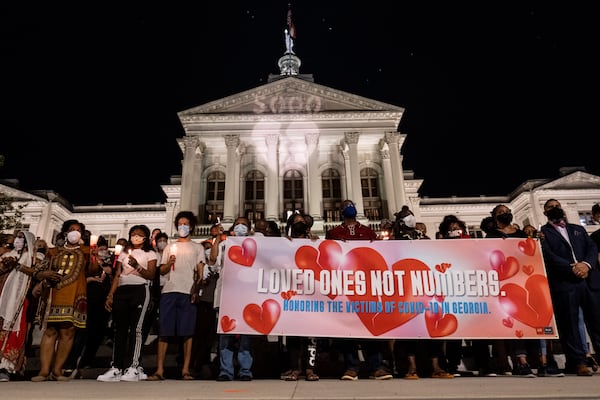 The number 5,000 is projected on the Georgia Capitol to illustrate the more than 5,000 people who have died from COVID-19 in Georgia. This followed a march Thursday evening Aug. 27, 2020, as part of the “Loved Ones, Not Numbers” campaign to humanize the toll of the current pandemic. Ben Gray for the Atlanta Journal-Constitution